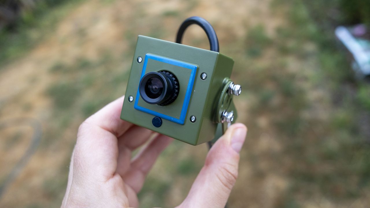Close up of the Green Feathers TV connectable wildlife camera held in a female hand