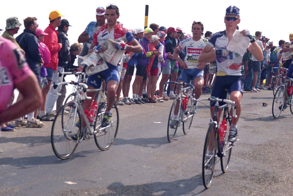 Riders grab newspapers to keep warm to keep warm on the descent off Mont Ventoux during the 1994 Tour de France