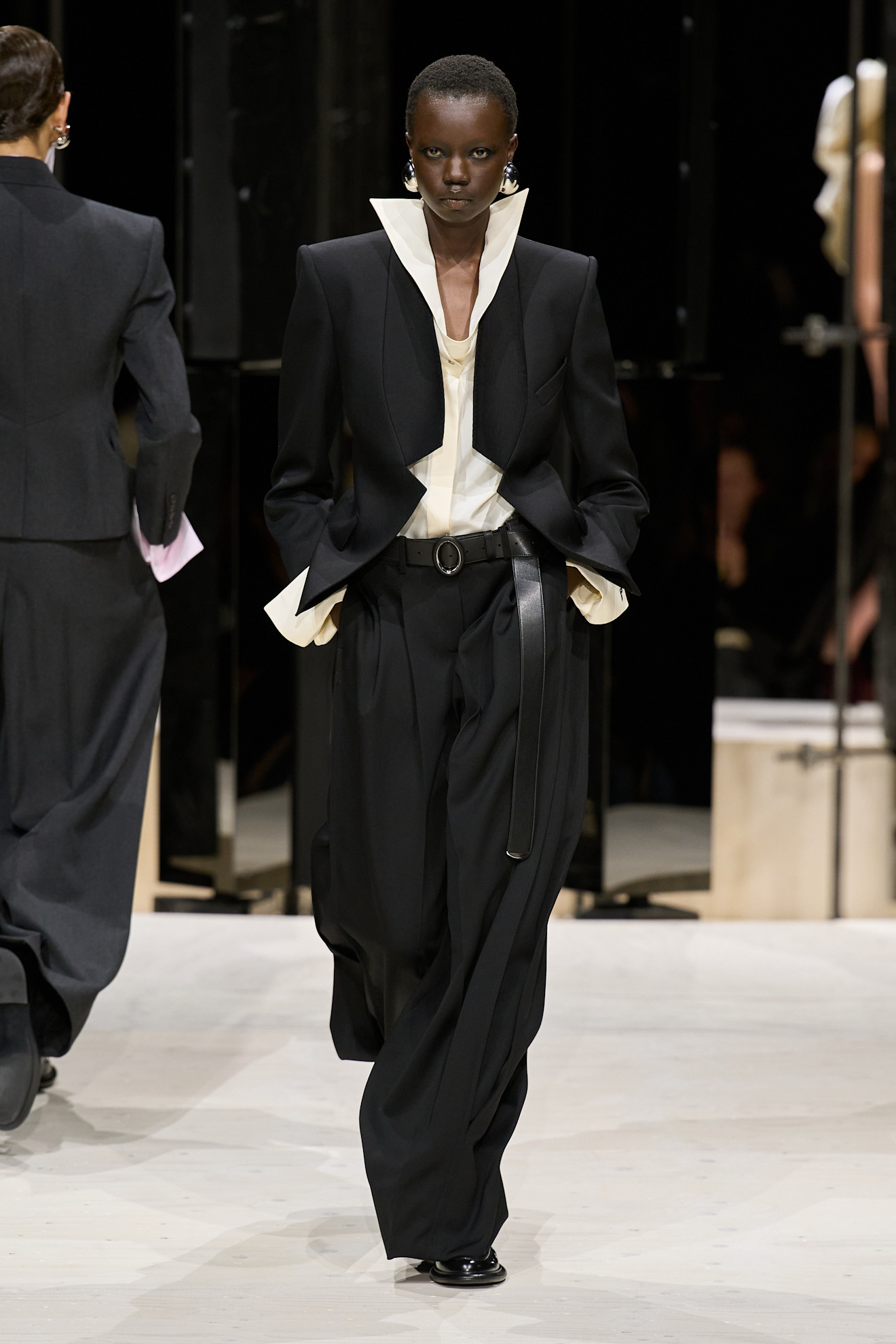 a model wears a tailored look at the givenchy f/w 26 show.