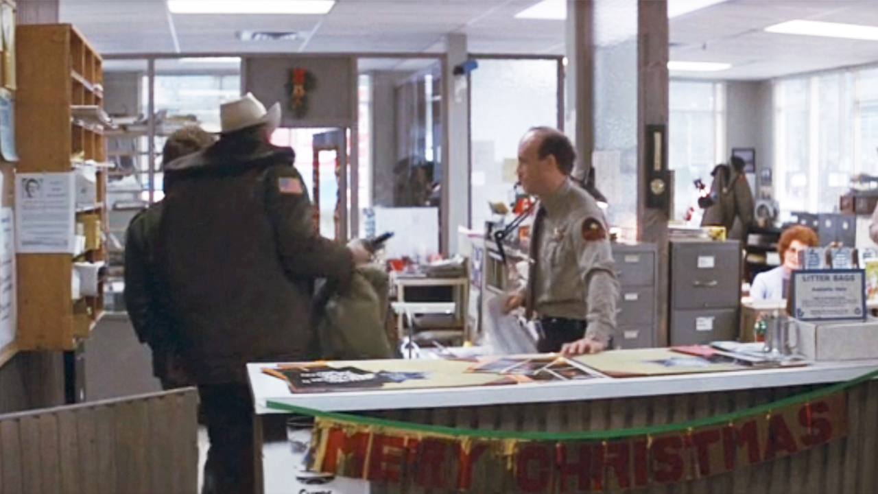 A Merry Christmas banner hanging up at the police station in First Blood.