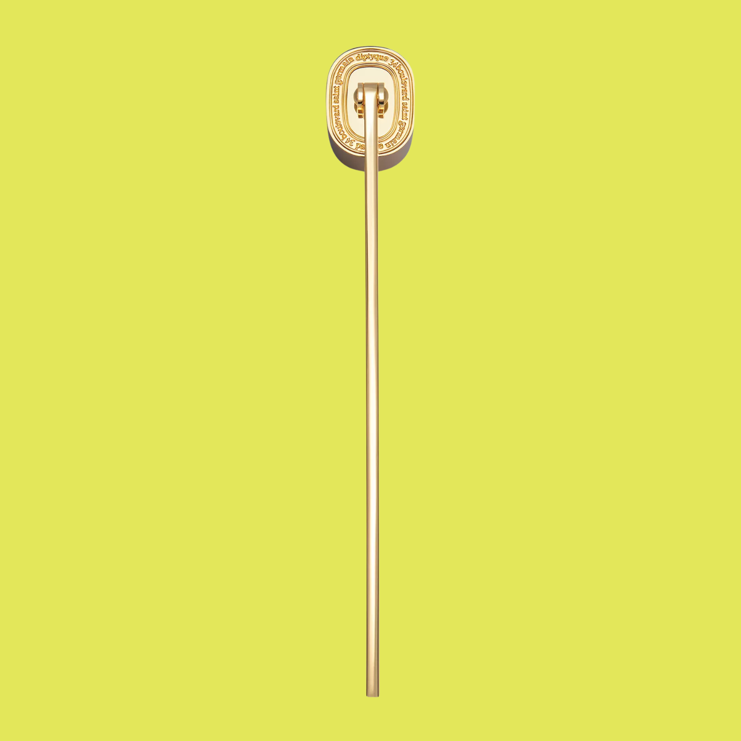 A gold-toned candle snuffer