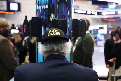 A trader sports a Dow 23,000 hat