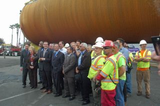 City dignitaries, California Science Center leadership and supervisors of the ET-94 transport crew assemble near the base of the huge fuel tank.