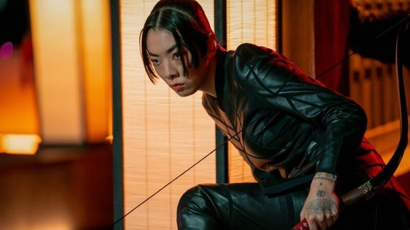 Rina Sawayama holding a bow and arrow in John Wick: Chapter 4