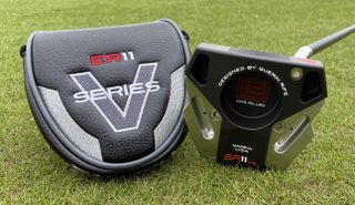 Evnroll ER11vx Putter resting on the golf course with its cool leather clubhead cover