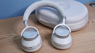 Cambridge Audio Melomania P100 SE headphones and case on a table.