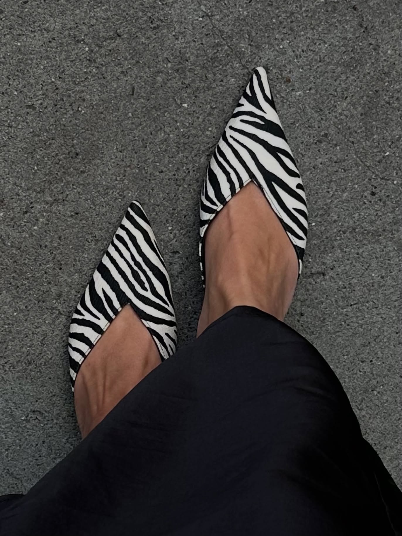 Dina Hansen wears zebra print flats.