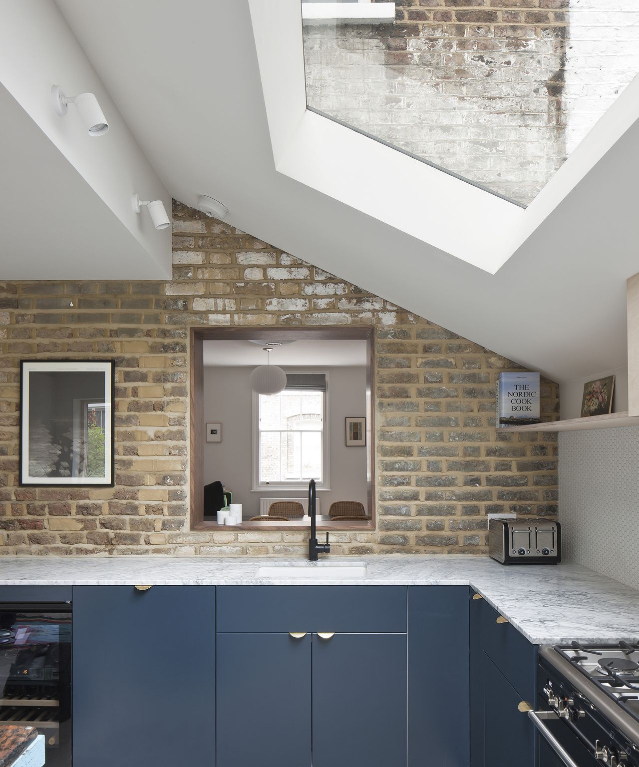 Pitched roof extension with skylight and modern kitchen with light work surfaces