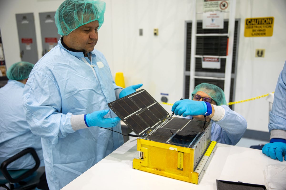 Team Miles works in a clean room at NASA's Kennedy Space Center in Florida to prepare their CubeSat to be launched on the Artemis 1 mission