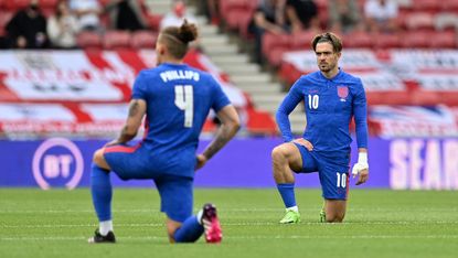 England players Kalvin Phillips and Jack Grealish take the knee before the match against Romania 