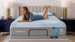 A woman in her pyjamas lying on her front on the Tempur-Pedic Tempur-ActiveBreeze smart bed