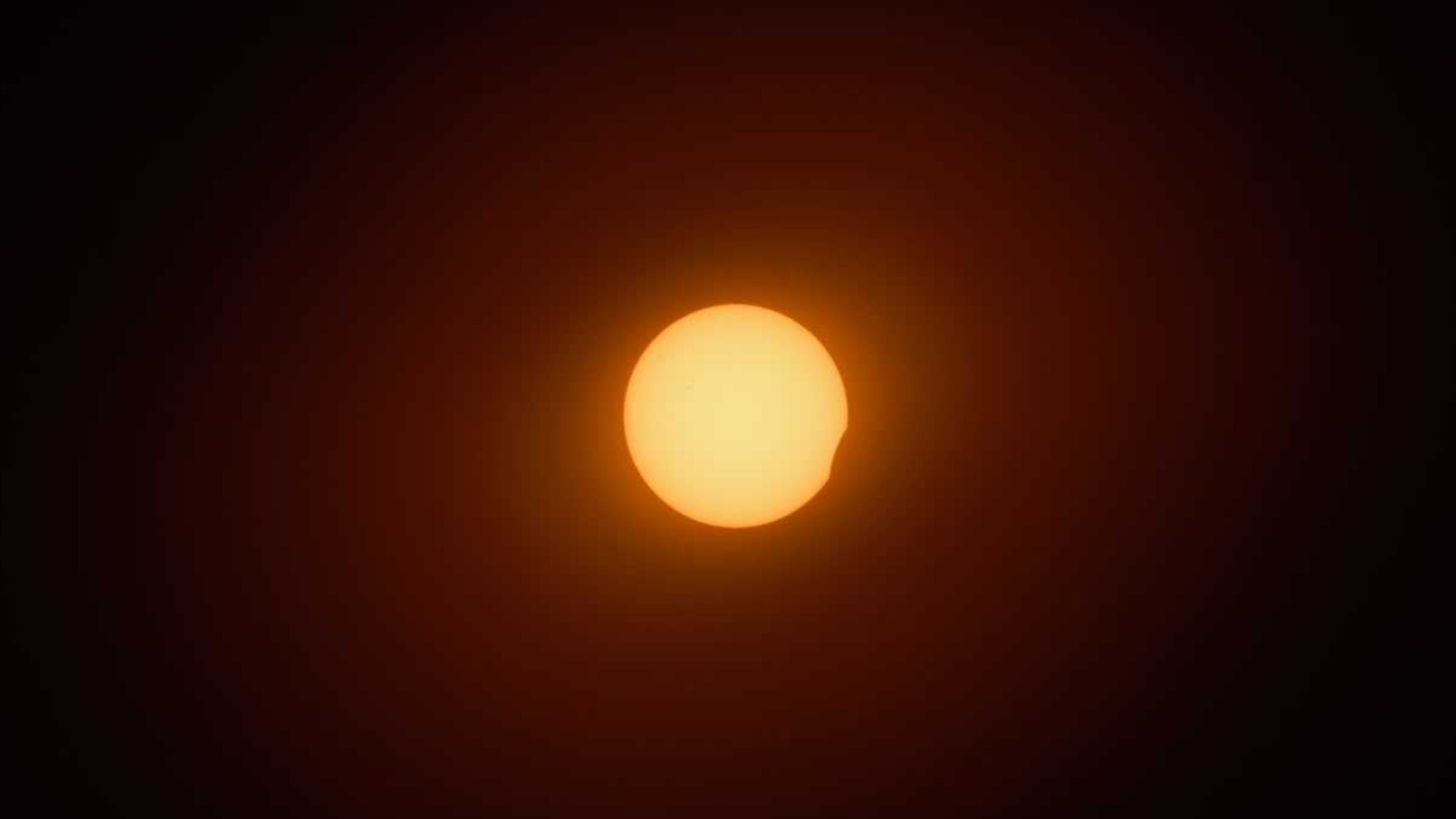 the sun with a small black section on one edge
