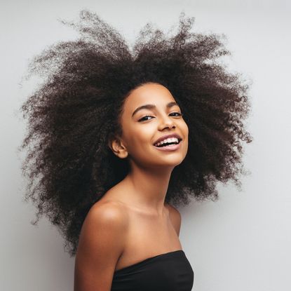Woman with textured hair smiling