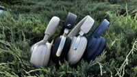 Four pairs of headphones lined up in a bush