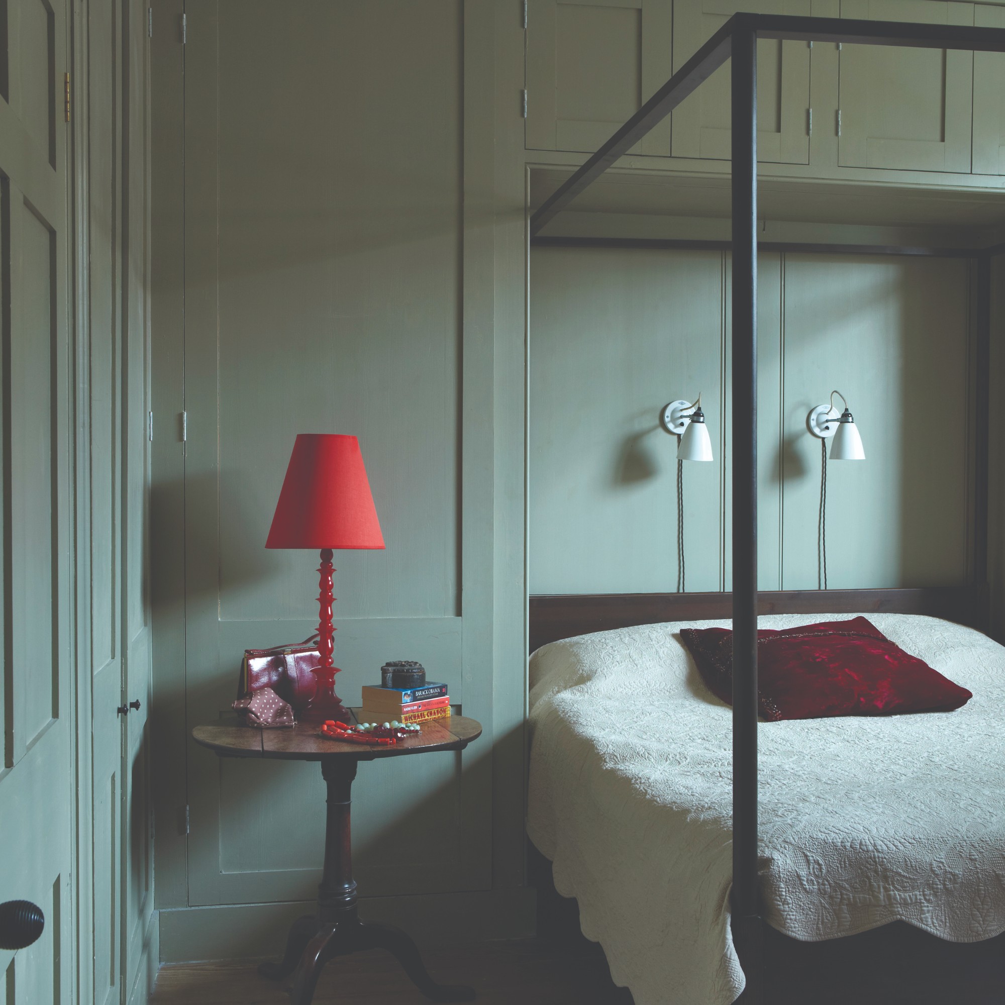 A bedroom colour-drenched in Farrow & Ball's French Gray paint with a four poster bed