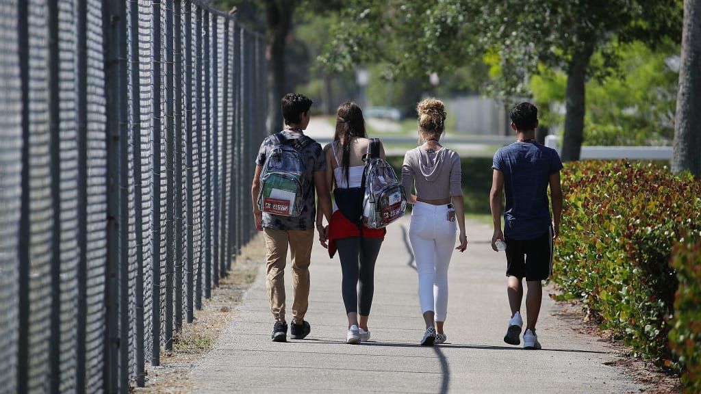 Teenagers walking down the street.