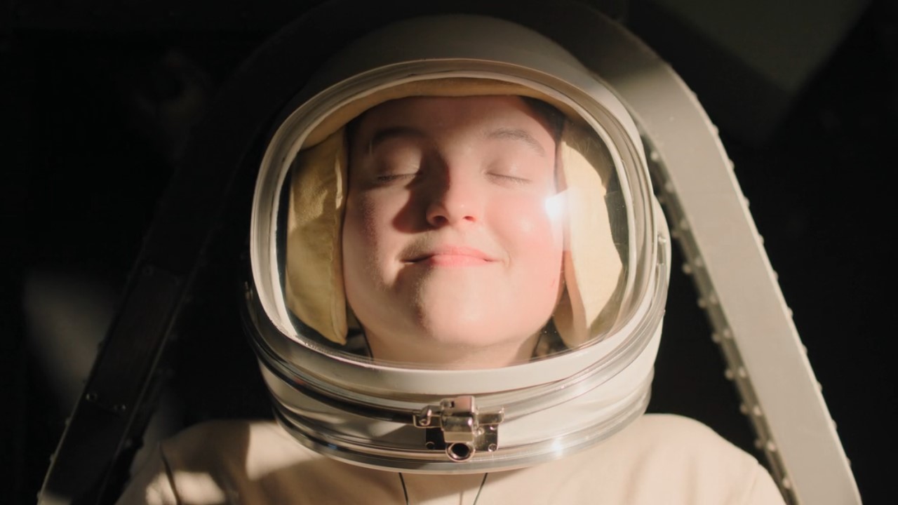 Bella Ramsey as Ellie pretending she's going to space in The Last of Us Season 2.