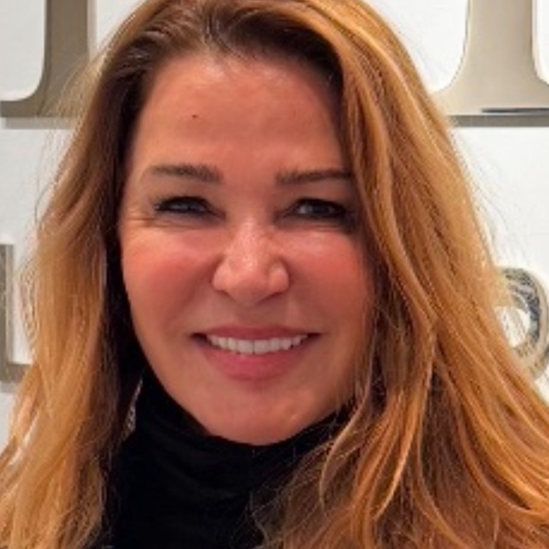 Sage Makeup smiles in a headshot.