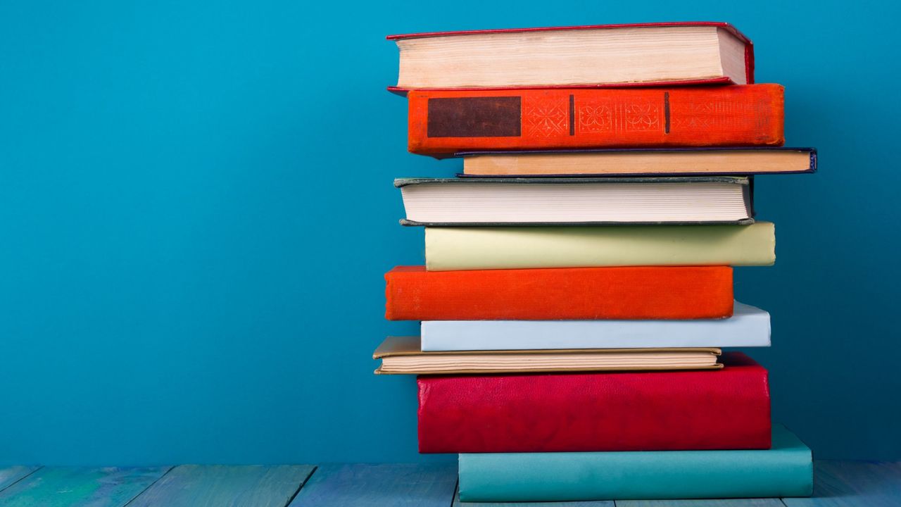 The Women&#039;s Prize for Fiction 2022 shortlist has been announced, here are Vintage old hardback books on a wooden shelf 