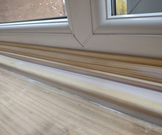 sanding a window sill