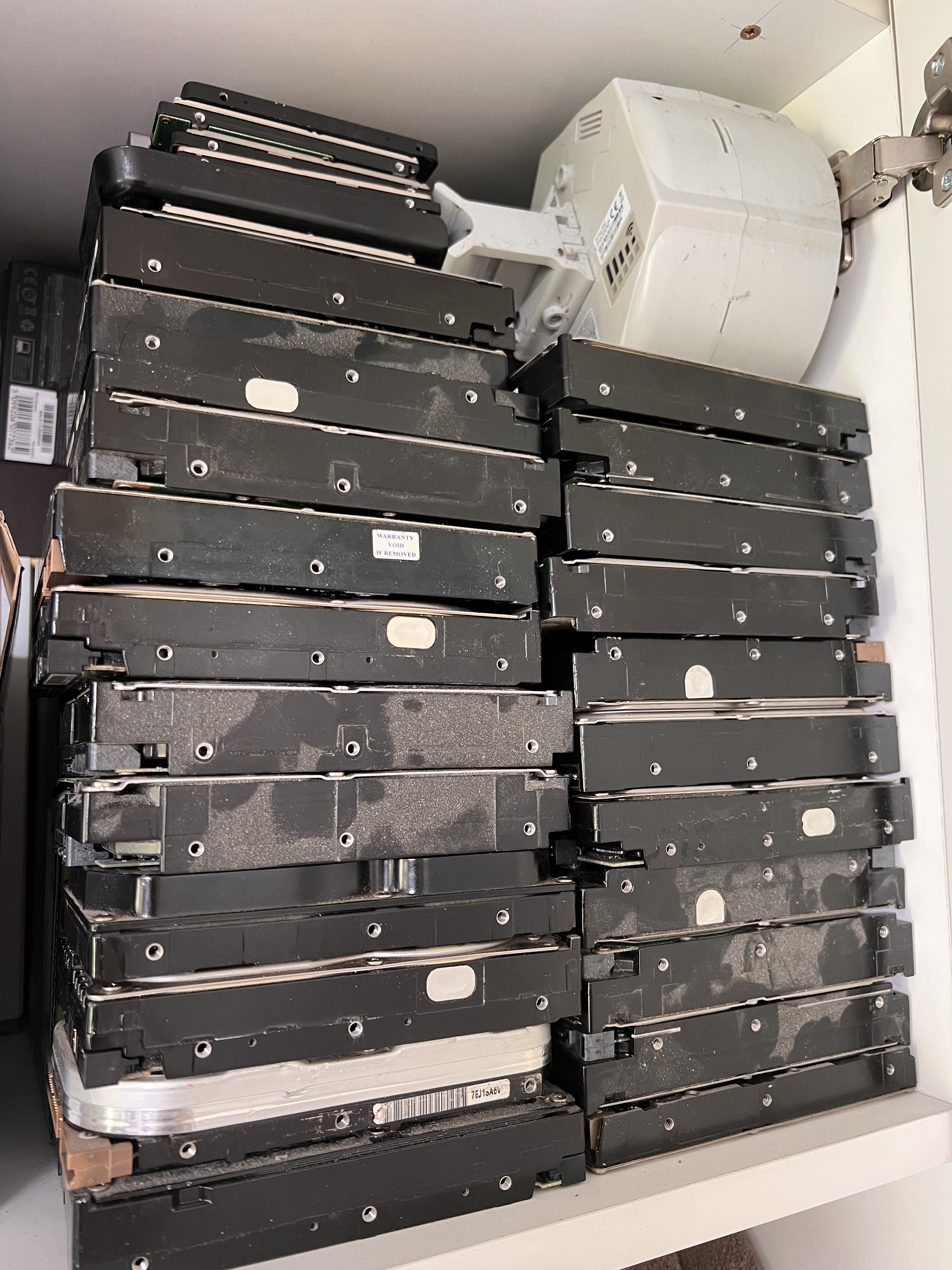 A mega amount of old hard drives in a cupboard