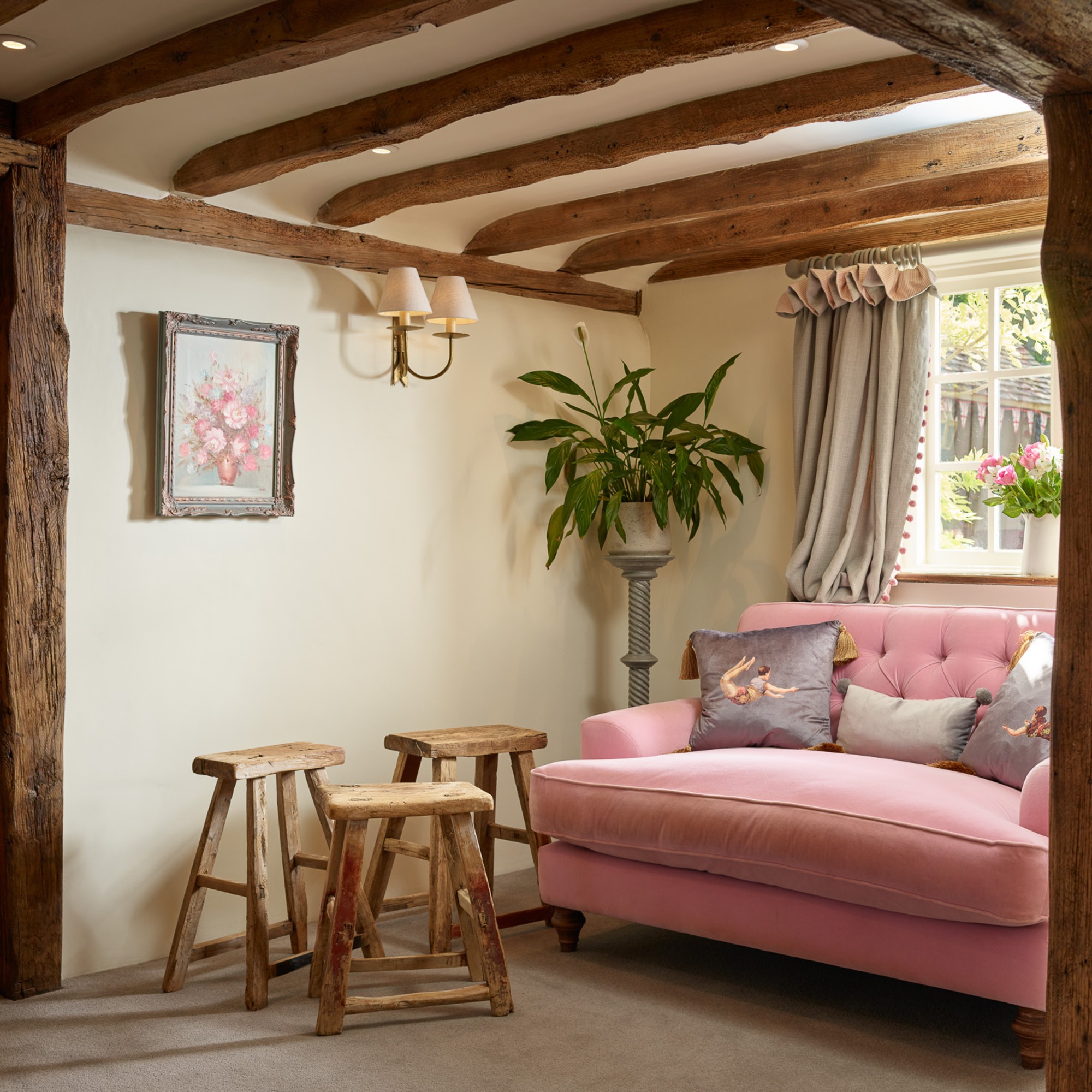 A butter yellow living room painted in Frenchic paints with a pink sofa