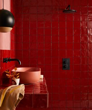 A red tile drenched bathroom