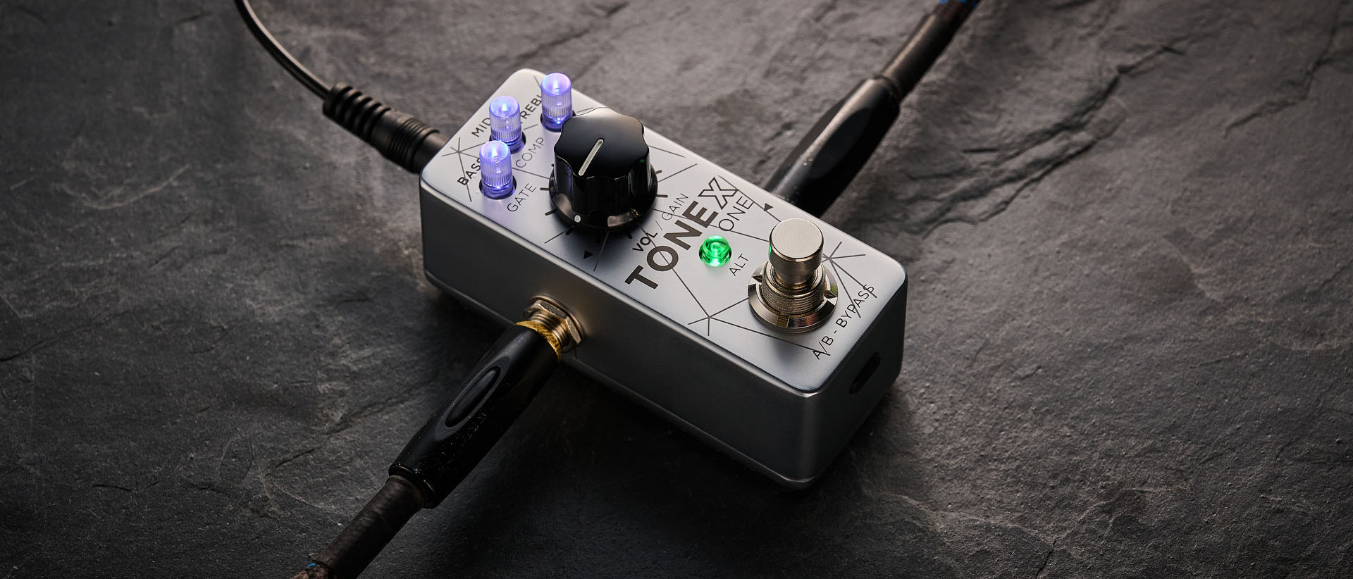 IK Multimedia Tonex One Bass: the mini-pedal offers amp modelling and heaps of tone options and is here photographed against a slate floor.