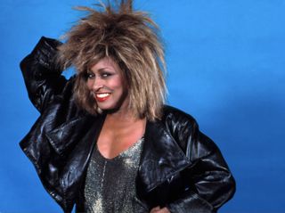 Tina Turner poses for a portrait backstage at the Joe Louis Arena during her "Private Dancer Tour" on August 18, 1985.