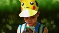 Leo, 9, looks at his phone during the Pokemon Go Festival on July 4, 2019 at the Westfalenpark in Dortmund, western Germany.