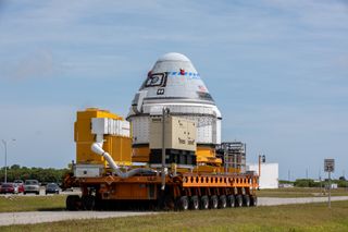 Boeing’s CST-100 Starliner spacecraft rolls out on May 4, 2022, to meet up with its United Launch Alliance Atlas V rocket.
