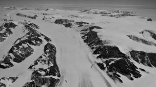 A view of a large glacier in a snowy wasteland.