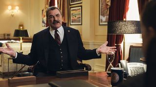 CBS set photo of Tom Selleck in a meeting.