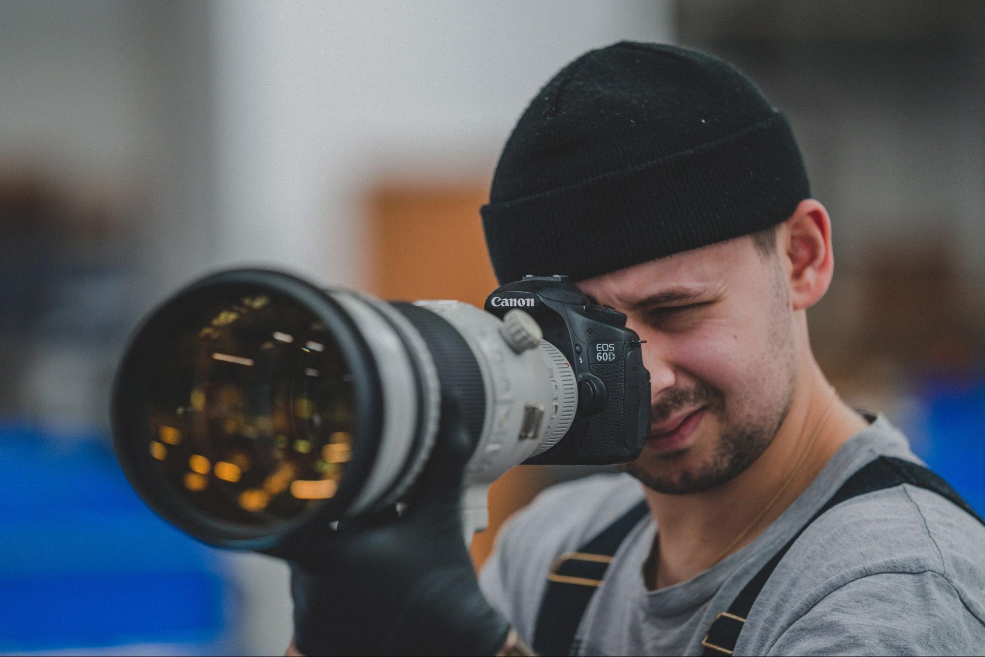 MPB staff inspects camera and zoom lens