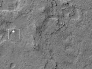 NASA's Mars rover Curiosity is spotted descending to the Martian surface under its parachute in this amazing photo by NASA's Mars Reconnaissance Orbiter on Aug. 5 PDT, 2012.