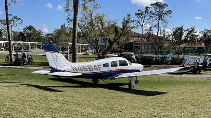 A plane lands on Del Tura Golf Course