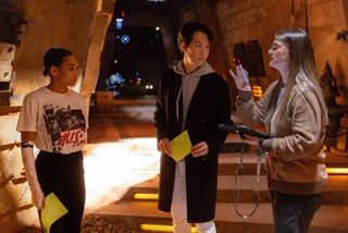 Amandla Stenberg and Lee Jung-Jae talk to writer-director Leslye Headland on the set of Star Wars: The Acolyte TV show