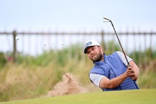 Daniel Brown strikes a wedge shot out of the bunker