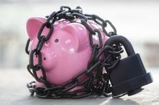 Pink piggy bank wrapped up in lock and chains