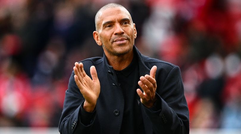 Stan Collymore applauds fans at the City Ground during Nottingham Forest&#039;s Premier League game against Everton in March 2023.