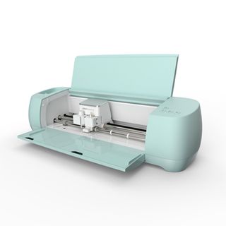 The best Cricut machines; a mint green digital craft machine with its lid and draw open so you can see its cutting blade