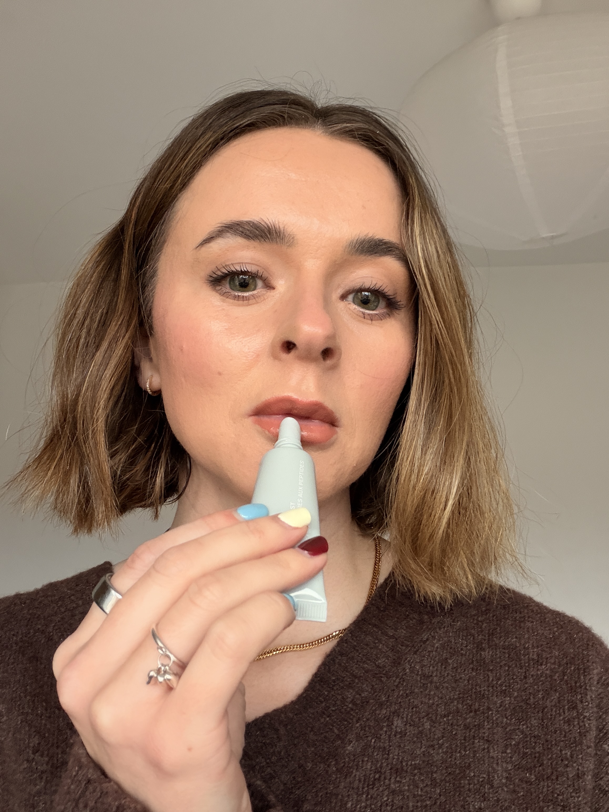 Freelance beauty editor, Grace Day, applying Rhode Peptide Lip Boost