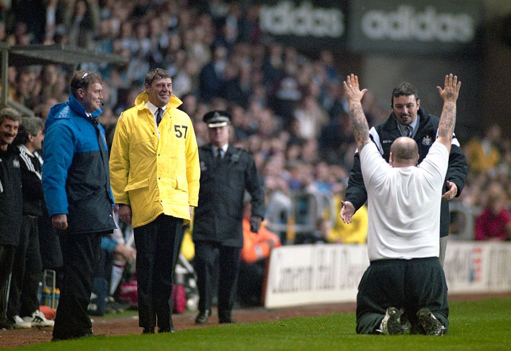 A Newcastle fan bows down to Kevin Keegan in the dugout during the side's 5-0 win over Manchester United in October 1996