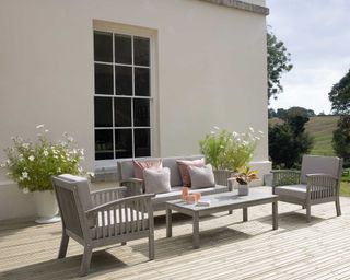 gripsure decking with furniture and planters with cosmos
