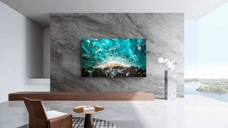 Wall-mounted TCL C641K in a modern marble living room