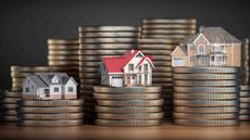 Model homes on top of stacks of coins