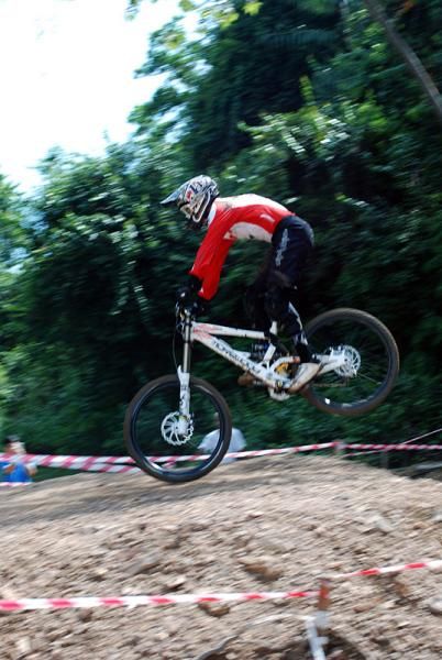 An elite men's downhill competitor about to touch down after catching some air.