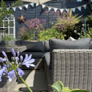 outdoor space with plants in pots and sofaset with cushions