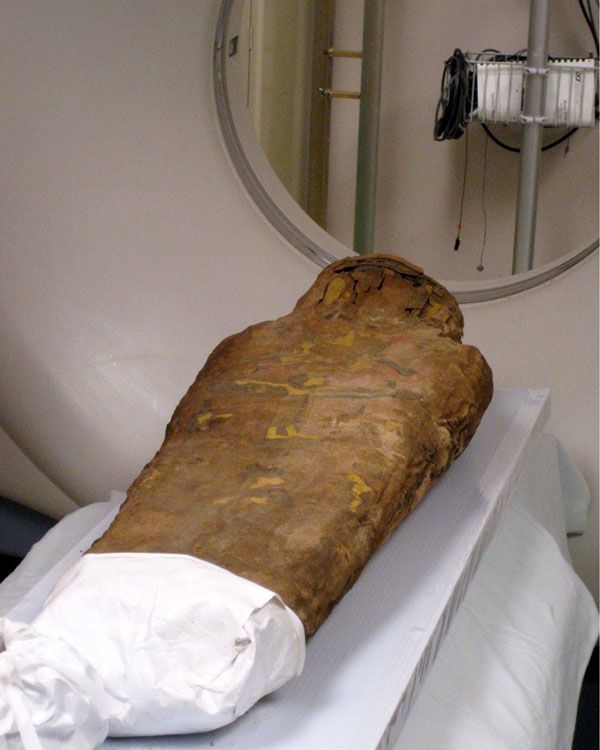 Child mummy goes into the CT scanner at a hospital. 