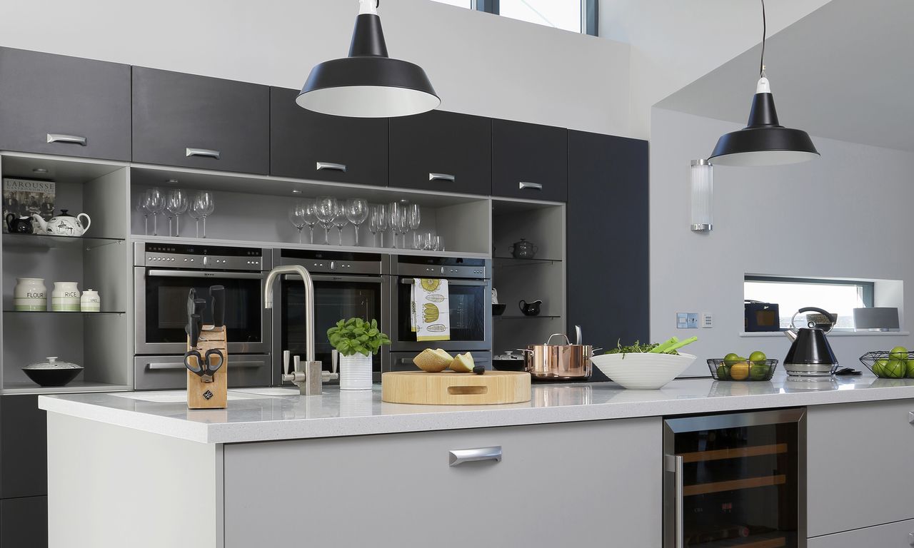 Grey and black kitchen with island and black pendant lights